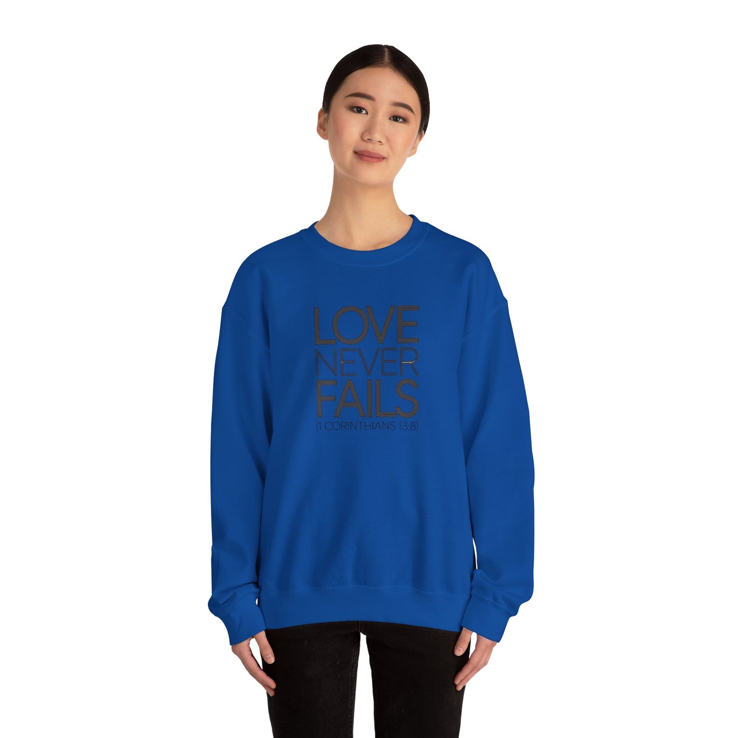 Love Never Fails  Unisex Heavy Blend™ Crewneck Sweatshirt