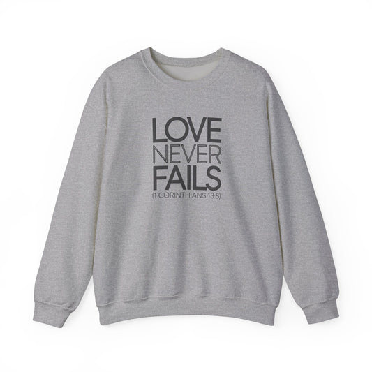 Love Never Fails  Unisex Heavy Blend™ Crewneck Sweatshirt