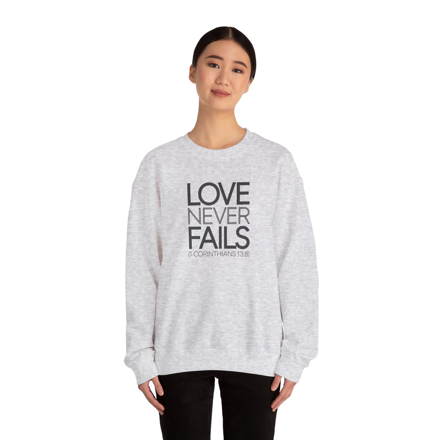 Love Never Fails  Unisex Heavy Blend™ Crewneck Sweatshirt