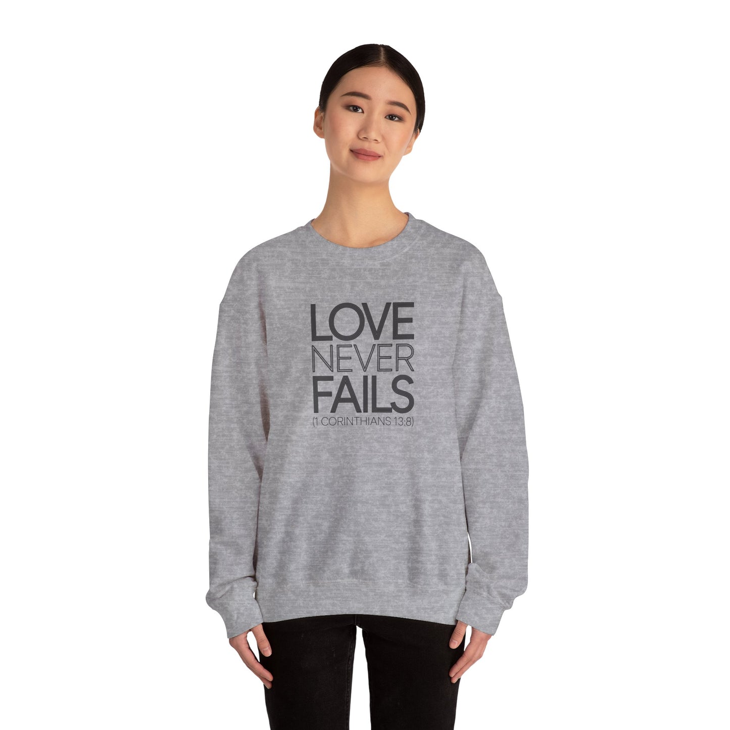 Love Never Fails  Unisex Heavy Blend™ Crewneck Sweatshirt