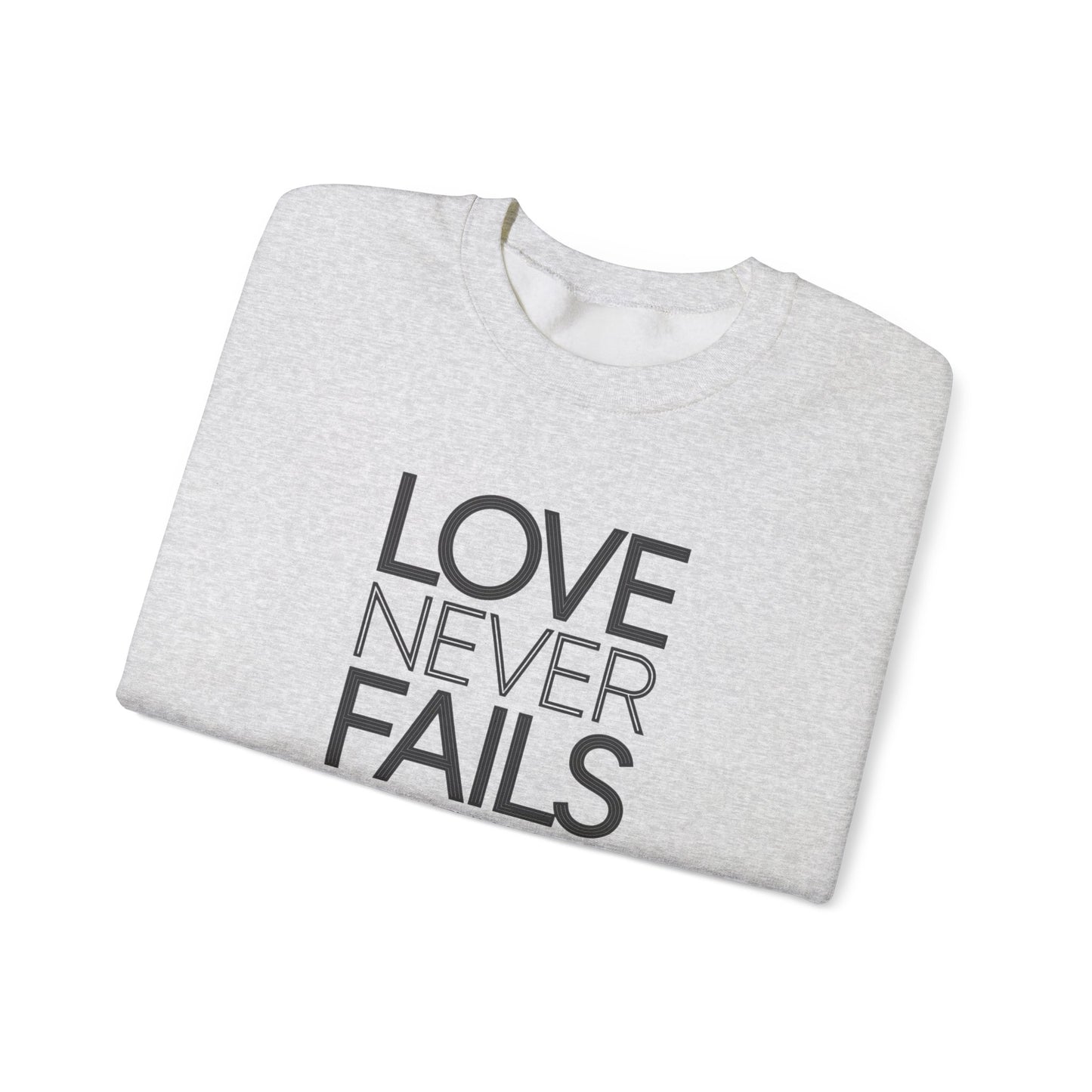 Love Never Fails  Unisex Heavy Blend™ Crewneck Sweatshirt